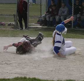 Korie Conder of Corvallis makes the slide into home during the Butte Central game but was tagged out by catcher Shannon McLaughlin. Jean Schurman photo.