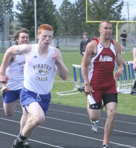 Tyler Coorough leans towards the finish line in the 100 meter race at the District 13C track meet. Coorough won four events and led the Pirates to a title. Jean Schurman photo.