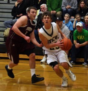 With his eye on the basket, Josh Schultz of Stevensville makes a move around Butte Central’s Colin Hollow. Butte Central won, 63-54. Schultz had 19 points. Jean Schurman photo